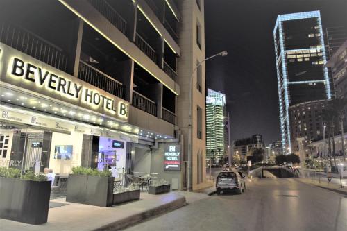 a car parked in front of a building at night at Beverly Hotel Beirut in Beirut