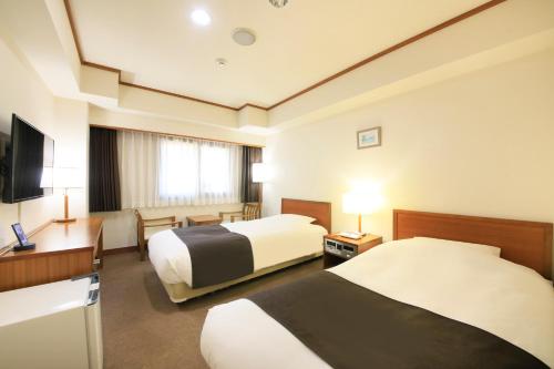 Tempat tidur dalam kamar di Maple Inn Makuhari