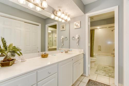 a white bathroom with a sink and a toilet at 2Br Penthouse in the Ocean Forest Plaza in Myrtle Beach