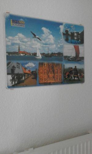 a picture on a wall with a picture of a harbor at Wikingerstadt 1 in Schleswig