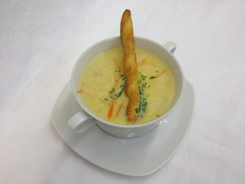 a white cup of soup with a stick in it at pension N.10 in Frymburk