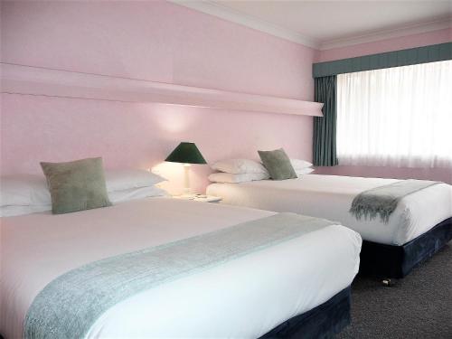 Postel nebo postele na pokoji v ubytování Tweed Heads Vegas Motel