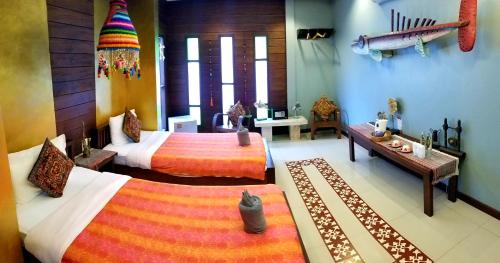 a large room with two beds and a table at Soi One Boutique Bedrooms in Pai