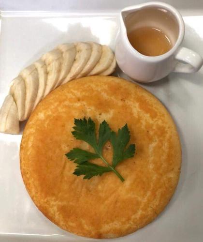 a pie with a parsley on top and a cup of tea at Soi One Boutique Bedrooms in Pai
