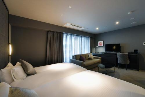 Un ou plusieurs lits dans un hébergement de l'établissement Hotel Trusty Nagoya Shirakawa