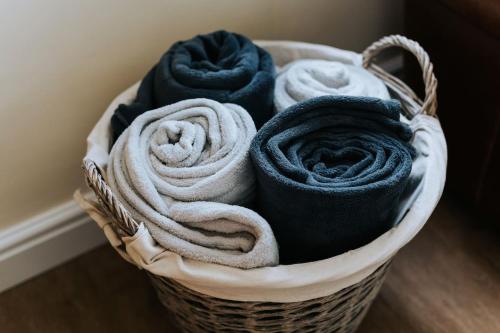 a basket filled with towels sitting on a floor at Sunset in Newquay