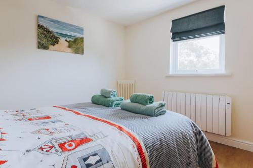 a bedroom with a bed and a window at Sunset in Newquay