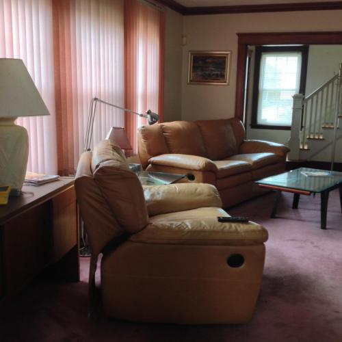 a living room with a couch and a table at Jacaranda in Milton