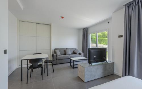 a living room with a couch and a table at Apartamentos Onzamar in Sanxenxo