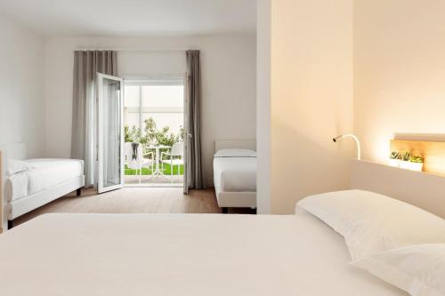 En eller flere senge i et værelse på Toscana Charme Resort
