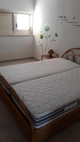 Postel nebo postele na pokoji v ubytování Bilocale vista spiaggia 10 metri dal mare