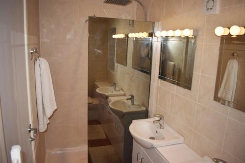 a bathroom with two sinks and two mirrors at Wings in Oakham