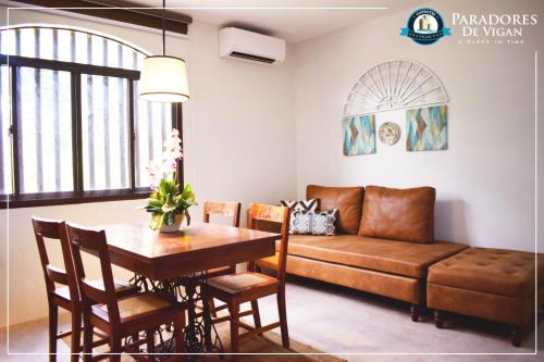 a living room with a table and a couch at Paradores de Vigan in Vigan