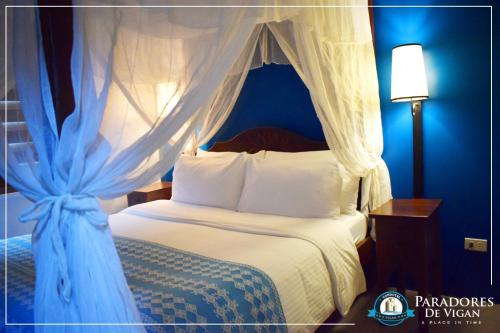 a bedroom with a bed with a canopy at Paradores de Vigan in Vigan