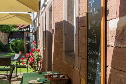 a table with a chalkboard on the side of a building at Hotel Vorderburg in Schlitz