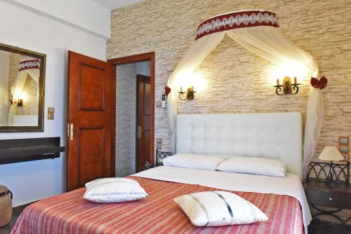 a bedroom with a bed with two pillows on it at Aegean Wave - Faros in Loutraki