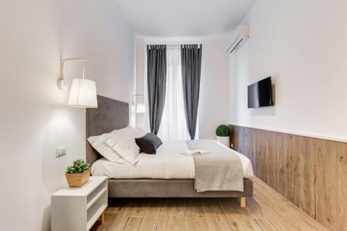 ローマにあるGermanico Luxury Apartmentのベッドルーム(ベッド1台、テレビ付)