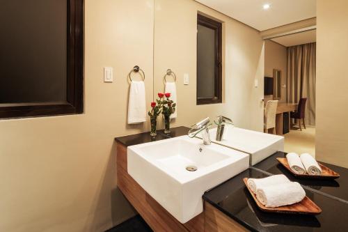 a bathroom with a white sink and a mirror at Villa Caemilla Beach Boutique Hotel in Boracay
