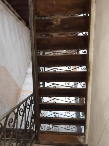 an old spiral staircase with iron railing at Joniskera in Tbilisi City