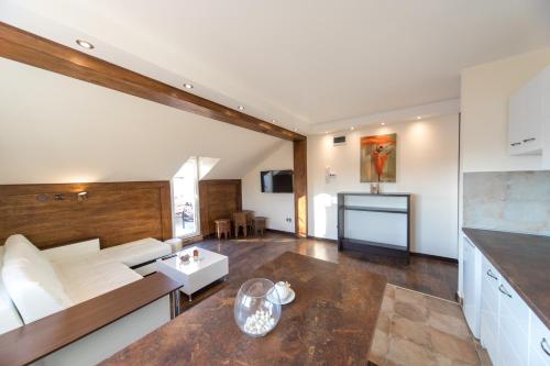 a living room with a couch and a table at New and Nice apartments in Kragujevac