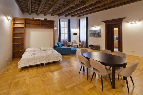 a bedroom with a bed and a table and chairs at Residence u Vejvodů in Prague