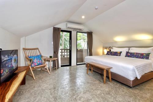 a bedroom with a large bed and a television at Deevana Krabi Resort in Ao Nang Beach