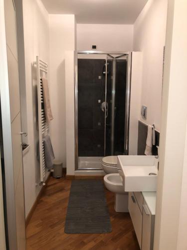 a bathroom with a shower and a toilet and a sink at Emma Home adiacente alla Piazza Ducale in Vigevano