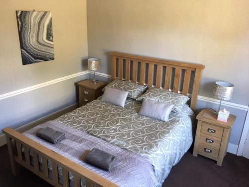 a bedroom with a large bed with two night stands at The Old Alma Inn Ltd in Chilham