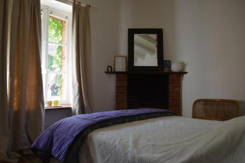 Le Noyer的住宿－LA PROVIDENCE，一间卧室配有一张带镜子的床和窗户