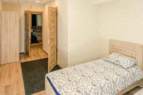 a bedroom with a bed and a closet at Everena Guest House in Rokiškis