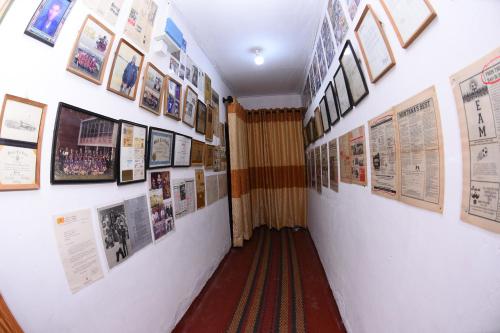 a hallway with posters and pictures on the walls at Suriya Ocean Villa in Wadduwa