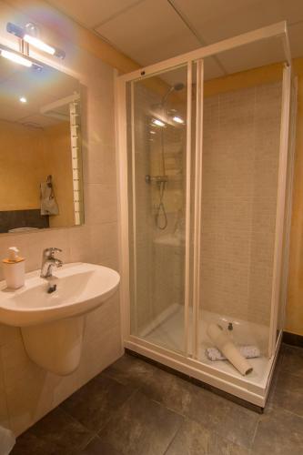 a bathroom with a shower and a sink and a shower at Casa Consales in Palau de Noguera