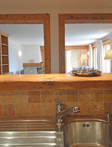 a kitchen with a sink and a mirror at Grands Ducs 328 in Bagnes