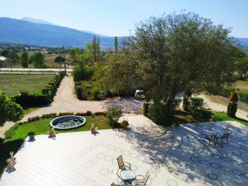 an overhead view of a patio with a tree and a fountain at Filoxenia Hotel in Ioannina