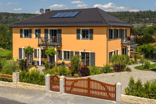 a house with solar panels on the roof at Landhaus Waltersdorf - Pool & Wellness in Bad Schandau