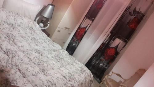 a bedroom with a bed and a lamp and a window at Villa Masullo in Mercogliano