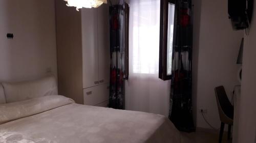 a bedroom with a white bed and a window at Villa Masullo in Mercogliano