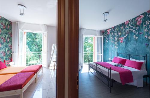 a bedroom with two beds with pink sheets and floral wallpaper at BOTANIKA in Bologna