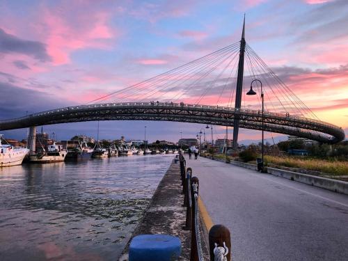 a bridge over a river with boats on it at Peperosa in collina B&B in Pescara