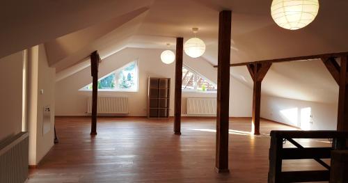 an attic room with wooden poles and lights at Carpen View Residence in Săcele