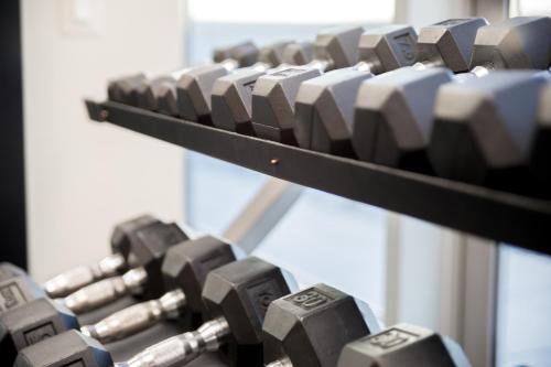 a row of dumbbells on a rack in a gym at Atlanta Furnished Apartments - Great location in the Heart of the City in Atlanta
