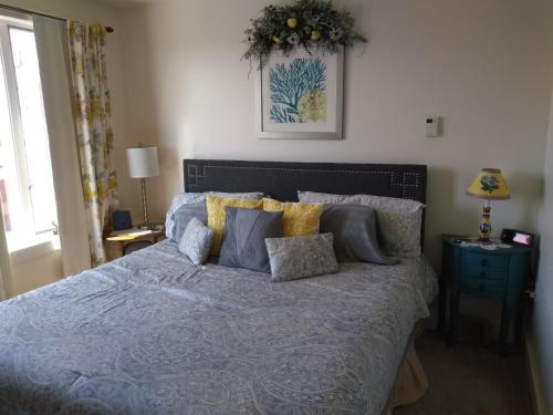 a bedroom with a bed with a blue comforter at 13 Hills Bed & Breakfast in South Acworth
