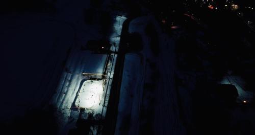 a car driving down a street at night at Pod Gromadzyniem Resort in Ustrzyki Dolne