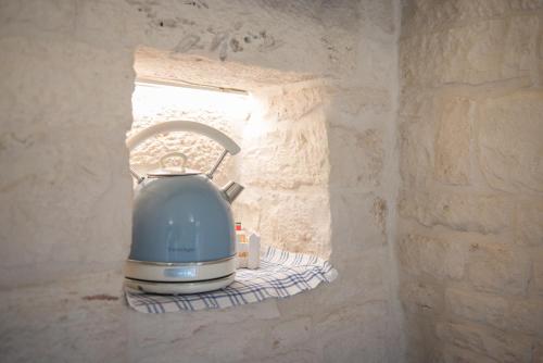 a toaster sitting on a shelf in a stone wall at Astra in Alberobello
