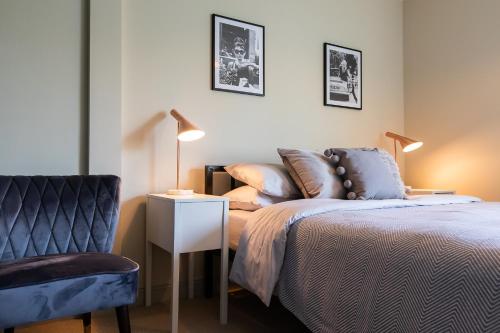 a bedroom with a bed and a chair at Unique Central Town House in Norwich