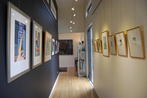 a hallway with a bunch of pictures on the walls at The Gallery Accommodation McCrae in McCrae