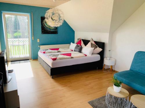 ein Schlafzimmer mit einem Bett und einer blauen Wand in der Unterkunft Lieblingsplatz in Altenstadt