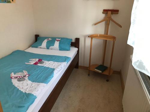 a bedroom with a bed with a dog wearing sunglasses at Alte Schule Niederdünzebach in Eschwege