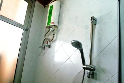 a shower head on the wall of a bathroom at Rose Garden Hotel in Phra Nakhon Si Ayutthaya
