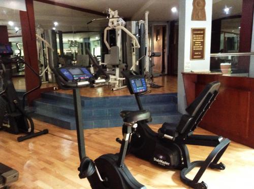 a gym with two treadmills and two exercise bikes at Crown Regency Residences Davao in Davao City